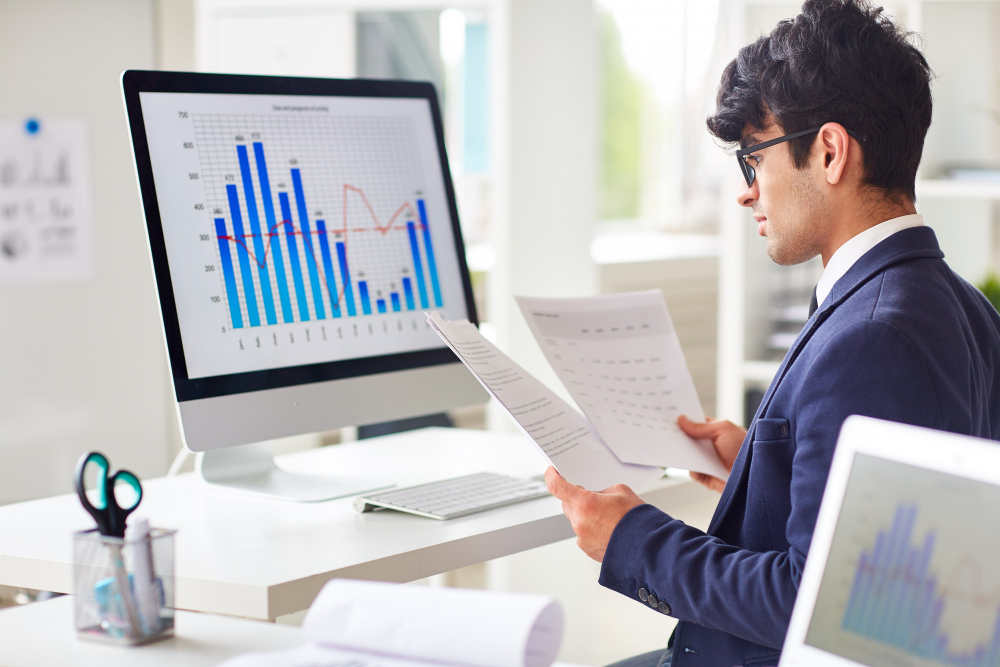 Actuarial science professional analysing statistical charts and financial data reports